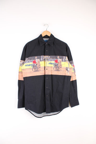 Vintage Wrangler Western Shirt in a black colourway with Cowboy photo printed across, button up with dagger collar, and has double chest pockets.