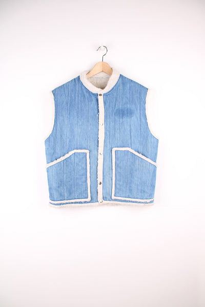 Vintage denim and shearling vest with front patch pockets and snap closure. 