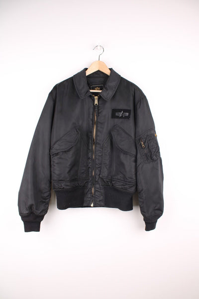 Alpha Industries black bomber jacket with zip closure, two front flap pockets and an arm pocket.