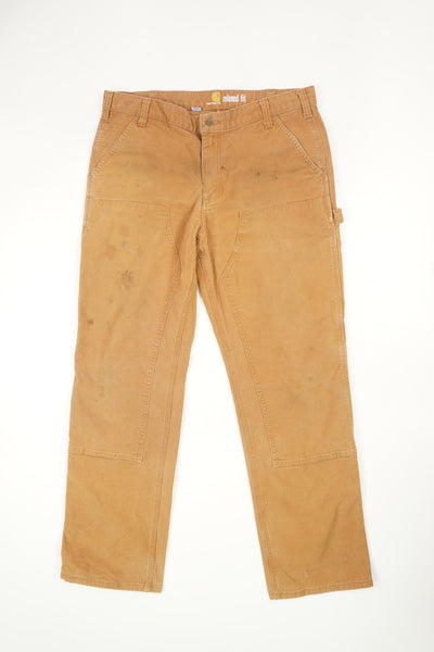 Tan Carhartt double knee carpenter style jeans with multiple pockets