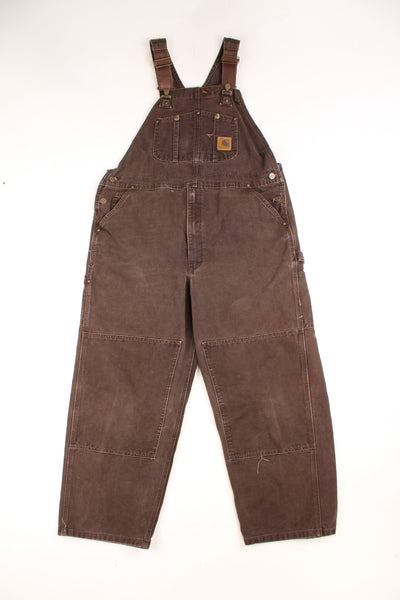 Brown Carhartt carpenter style full length, double knee dungarees with embroidered logo on the chest pocket 