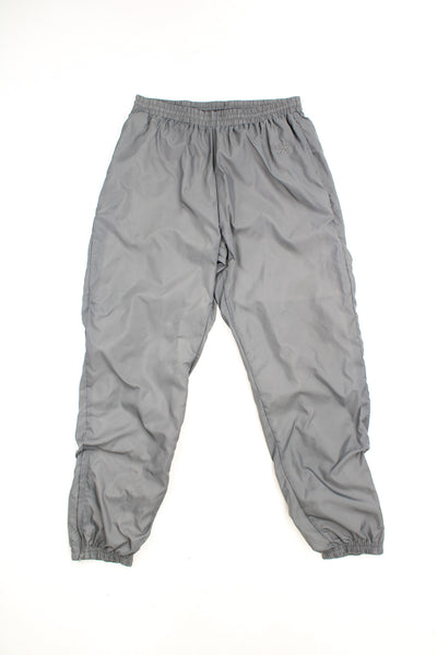 Reebok Tracksuit Bottoms in a grey colourway, adjustable waist, cuffed at the bottom, and has the logo embroidered on the front.