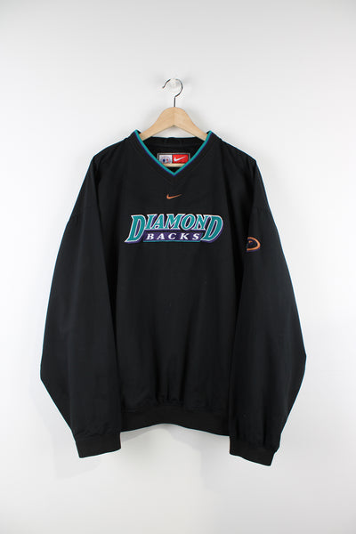 Vintage Nike Diamond Backs MLB training top in black, v neck with two side pockets, has centre swoosh and Diamond Backs spell-out on the front.