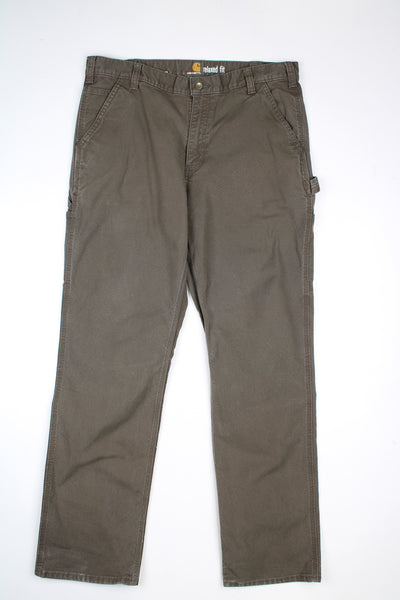 Khaki green denim jeans from Carhartt with a relaxed carpenter style fit and multiple pockets