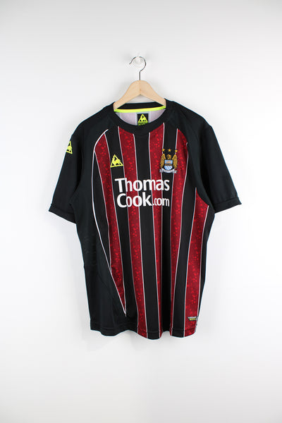 Vintage Manchester City 2008/09, Reebok Away Football Shirt, black and red colourway, Ireland number 7 printed on the back, and has logos printed on the front.