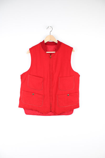 Vintage 1950's Woolrich Gilet in a red colourway, woollen shell and has a quilted nylon lining, zip up with multiple pockets, talon zip and has the label embroidered on the inside.