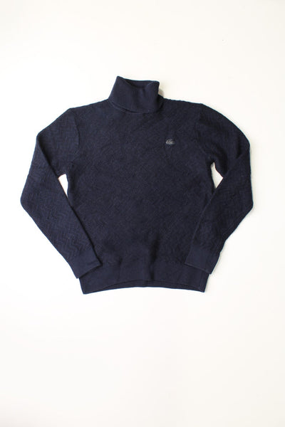 Lacoste navy blue roll-neck knit jumper with logo applique in black leather.  