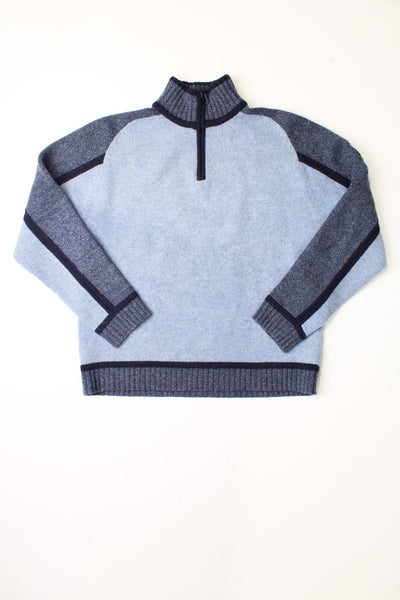 Kickers light blue knit quarter-zip jumper with grey-blue stripe detailing around the neck and shoulders, and a Kickers patch logo on the left sleeve. 