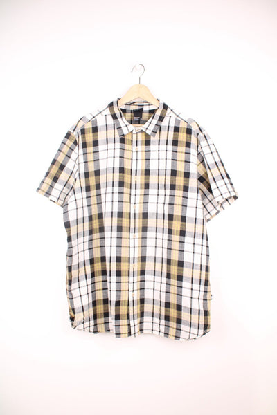 The North Face Short Sleeve Shirt in a white, black and yellow plaid colourway, button up and has a chest pocket. 