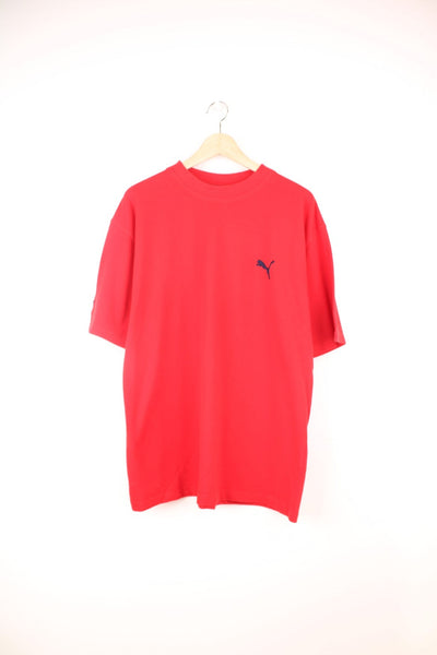 Vintage Puma T-Shirt in a plain red colourway and has the logo embroidered in black on the front and right sleeve.