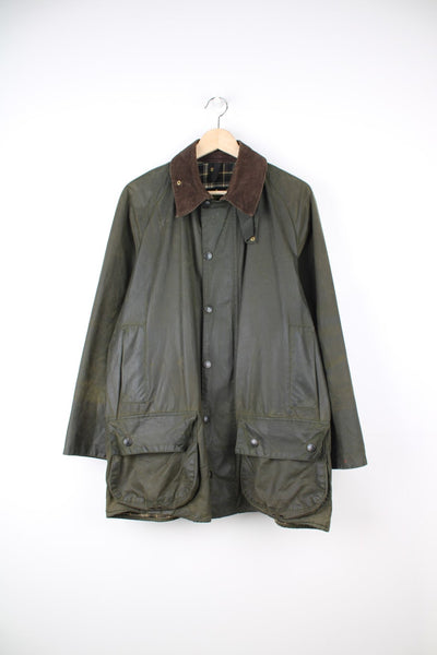 Vintage Barbour Beaufort Wax Jacket in a green colourway with a brown corduroy collar, zip up with multiple pockets, and has a tartan lining.