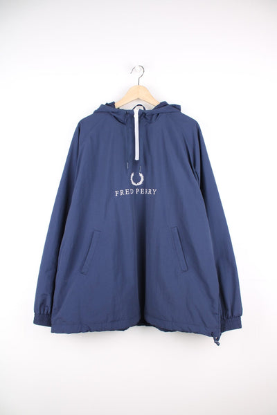 Fred Perry Pullover Jacket in a blue colourway, quarter zip with side pockets, hooded and has the logo embroidered across the front.