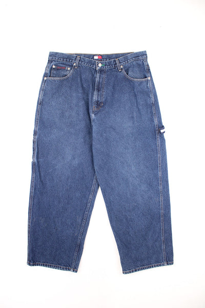 Tommy Hilfiger dark wash carpenter jeans with branded strap and embroidered logo on the waistband