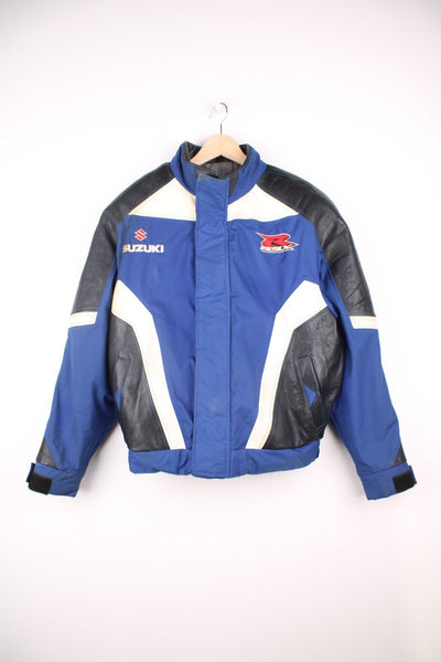 Vintage Suzuki racing jacket in blue, black and white. Features embroidered logo. 