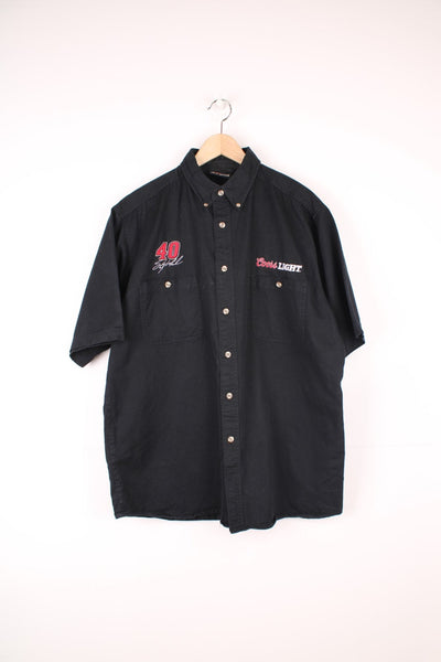 Chase Nascar Racewear, Coors Light Shirt in a black colourway, button up with double chest pockets, and has the brand logos above each pocket.