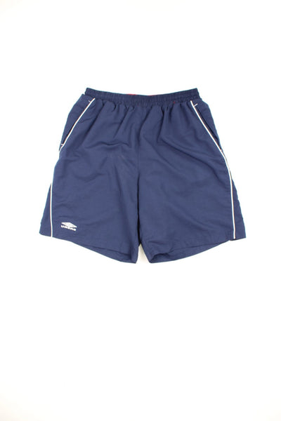 Blue Umbro shorts with drawstring waist and embroidered logo on each leg. 