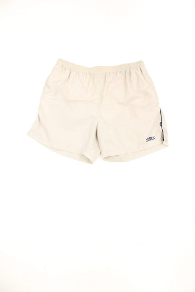 Beige vintage Umbro swim shorts with elasticated drawstring waist and embroidered logo. 