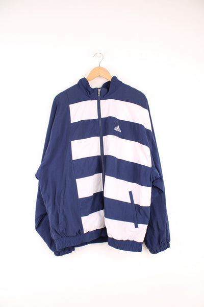 Blue and white Adidas striped tracksuit top. Features embroidered logo on the chest.