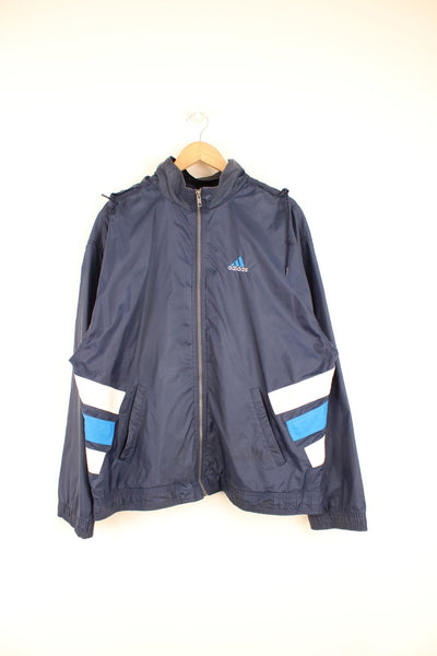 Vintage Adidas tracksuit top with white and blue panel details, embroidered logo on the chest and pack away hood.