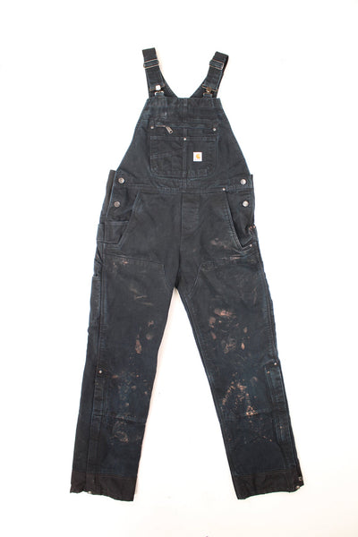 Carhartt Dungarees in a black colourway, multiple pockets, quilted lining, and has the logo embroidered on the front. 